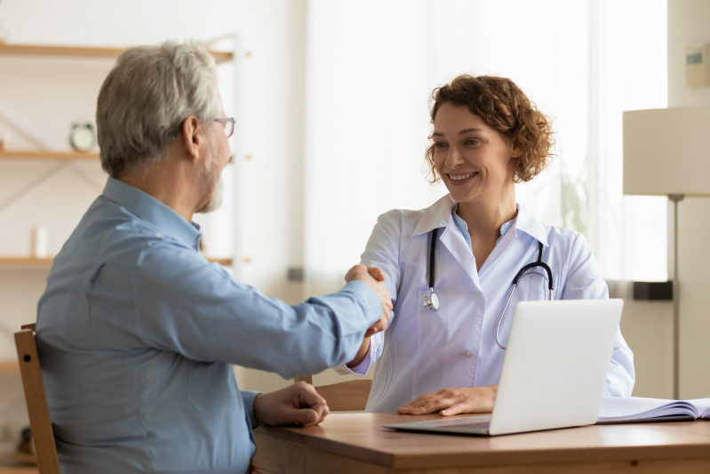 pharmacist shaking patient's hand